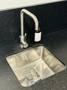 a kitchen sink with a faucet on a counter at Departamento INDIGO in Mendoza