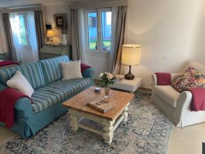 a living room with a blue couch and a coffee table at Tenuta Le Mandorlaie, Agriturismo in Scansano in Scansano +52 photos