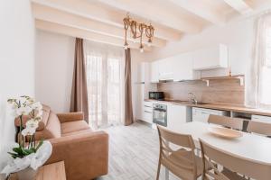 a kitchen and living room with a couch and a table at Lido Blu - Beachfront Suites & Apartments in Lido di Camaiore
