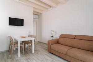 a living room with a couch and a table at Lido Blu - Beachfront Suites & Apartments in Lido di Camaiore