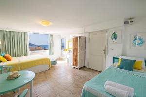 a hotel room with two beds and a table at Kuytu Bed & Breakfast in Kas