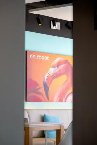 a screen with a picture of a flamingo on it at Onmood Cala Ratjada - New Opening 2024 in Cala Ratjada