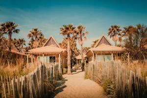 a house with palm trees and a fence at Toison D'or in Saint-Tropez
