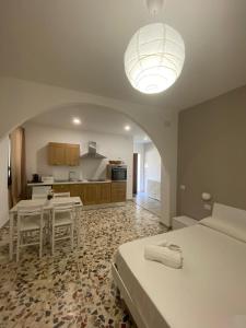 a large room with a bed and a kitchen at Da Peppino e Nicchella in Marina di Camerota