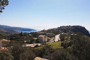 a view of a town with a road on a hill at Philoxenia Guest Studio in Himare