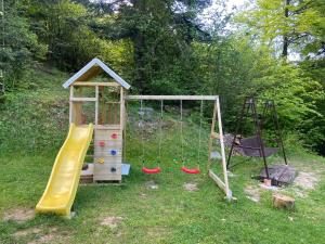 een speeltuin met een glijbaan en een schommel bij Chalet Kosorky in Čadca