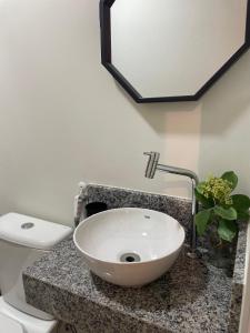 a bathroom with a sink and a toilet at Apartamento na Batista Campos 02 quartos in Belém
