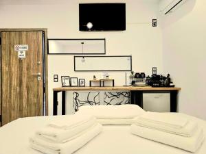 a bedroom with a bed with two white towels at Philoxenia Guest Studio in Himare