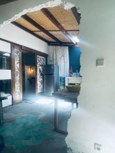 a kitchen with a table and a refrigerator in a room at Studio On Air in Gili Islands