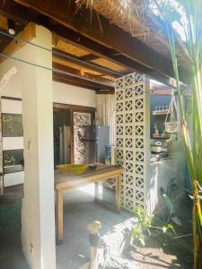 a kitchen with a table and a refrigerator at Studio On Air in Gili Islands