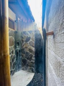 a glass door of a stone wall with a window at Studio On Air in Gili Islands +38 photos