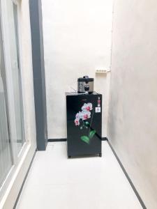 a refrigerator with a picture of a flower on it at Villa risky A11 in Tlekung
