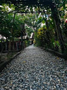a cobblestone road with a bridge over it at Busy Bee Guest House in Sauraha