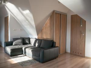 a living room with a couch and a staircase at Villa Bella Italia III in Mikołajki