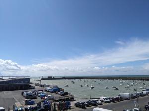 a group of boats in the water in a harbor at La Vigie sur le Port in Granville