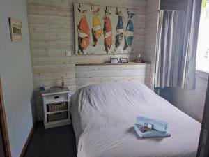 a bedroom with a bed and a picture of surfboards at La Vigie sur le Port in Granville