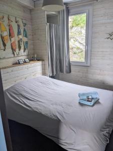 a bedroom with a bed with a towel on it at La Vigie sur le Port in Granville