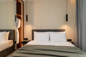 a bedroom with a bed with white pillows at Villa Linea Verde I by Sealand Villas in Tsilivi +21 photos
