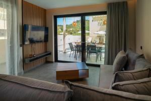 a living room with a couch and a table at Villa Linea Verde I by Sealand Villas in Tsilivi