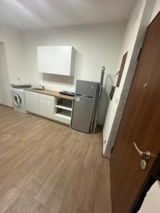an empty kitchen with a refrigerator and a counter at HOUSE SAN FILIPPO in Naples