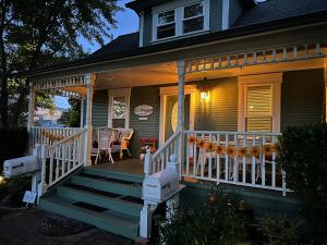 a front porch of a house with a white railing at Second Street Cottages in Ashland