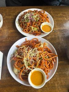 un tavolo con due piatti di spaghetti e due ciotole di sugo di Paradise Boutique Hotel a Pokhara