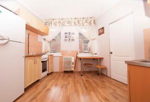 a kitchen with a table and a desk in it at apartments on Chkalova in Dnipro +7 photos