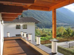 a balcony with a view of a house at Ferienwohnung Bergpanorama in Fulpmes