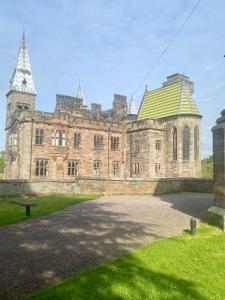 a large stone building with a green roof at The White Hart Apartment Valley View in Alton