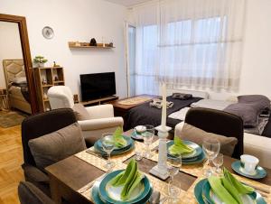 a living room with a table and chairs and a couch at Apartman Elizabet in Pirot