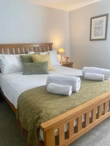 a bedroom with a large bed with two pillows on it at The White Hart Apartment Valley View in Alton