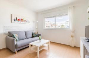 a living room with a couch and a window at A 20 metri dalla Spiaggia in Puerto del Rosario