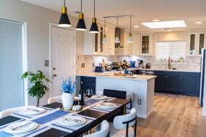 a kitchen with a dining table and a kitchen with blue cabinets at Lakeview Haven! Nature's Retreat with Serene Views in Lago Vista