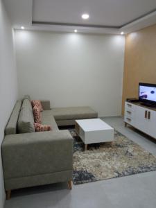a living room with a couch and a tv at Ben arous one in Ben Arous