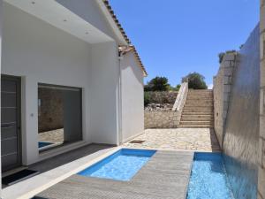 a villa with a swimming pool next to a house at Villa Lefkas - Luxury villa Sivota with direct sea access in Sivota