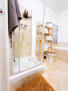 a bathroom with a shower and a toilet at Minimalistic apartment in Crystal Palace in Crystal Palace