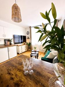 a living room with a wooden table with wine glasses on it at Minimalistic apartment in Crystal Palace in Crystal Palace