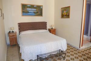 a small bedroom with a bed and two night stands at B&B Domus Gemi in Naples