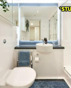 a bathroom with a toilet and a sink and a mirror at Student Only Ensuite Rooms Zeni Bournemouth in Bournemouth