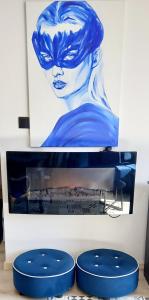 two pictures of a painting of a woman at Gold Apartament in Wałbrzych
