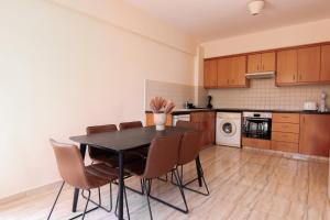 a kitchen with a dining room table and chairs at Phaedrus Living: Universal City Flat Alina in Paphos City