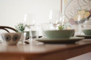 a table with glasses and a bowl and plates on it at Apartement Nähe Red Bull Ring TOP4 in Judenburg +4 photos