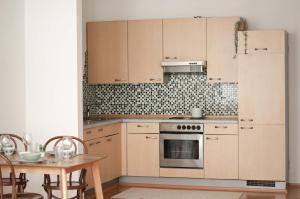 a kitchen with a refrigerator and a table with chairs at Apartement Nähe Red Bull Ring TOP4 in Judenburg