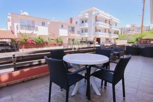a table and chairs on the roof of a building at Phaedrus Living: Universal City Flat Alina in Paphos City