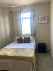 a small bedroom with two beds and a window at Apartamento na Batista Campos 02 quartos in Belém