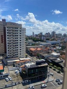 a view of a city with cars parked in a parking lot at Apartamento na Batista Campos 02 quartos in Belém
