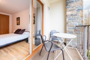 a room with a bed and a table and chairs at Apartamento TINTIN en Arinsal in Arinsal