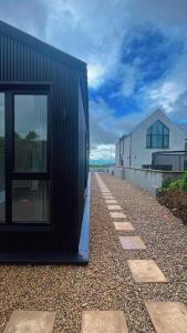 a black house on the side of a building at Deerpark luxury 3 bed retreat in Cashel