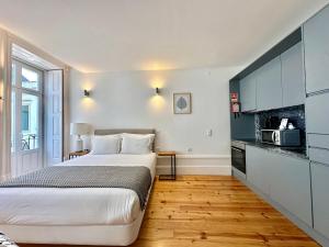 a hotel room with a bed and a kitchen at YOUROPO - Stories in Porto