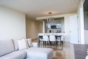 a living room and kitchen with a couch and a table at Oceanview Apt Near Panama City w/ King Bed & More in Playa Bonita Village